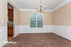 Charlotte house for rent - a dining room with a chandelier and a window