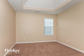 Charlotte house for rent - a bedroom with a carpeted floor and a window