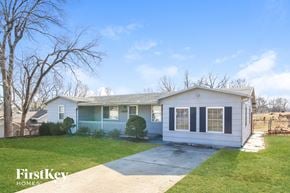 Kansas City house for rent - the front of a white house with a driveway and grass