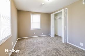 Kansas City house for rent - a bedroom with carpet and a closet and a window