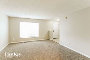 Columbus house for rent - A room with a carpeted floor and a window letting in natural light.