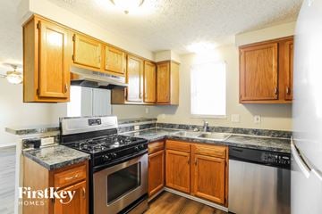Columbus house for rent - A kitchen with wooden cabinets and stainless steel appliances.