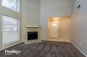 Spring house for rent - A room with a fireplace and a door leading to another room.