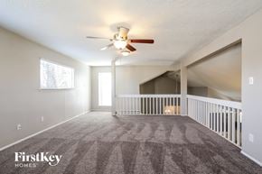 Spring house for rent - A spacious room with a carpeted floor and a ceiling fan.