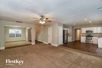 College Park house for rent - A spacious living room with a kitchen in the background.