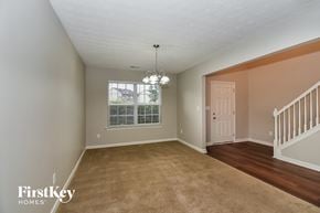College Park house for rent - A room with a carpeted floor and a staircase.