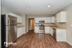College Park house for rent - A kitchen with wooden floors and stainless steel appliances.