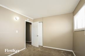 Indianapolis house for rent - a bedroom with a door to a closet and a window