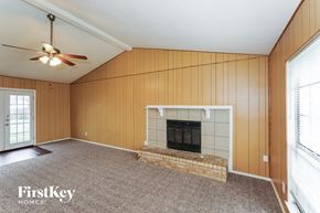 Grand Prairie house for rent - a living room with a fireplace and a ceiling fan