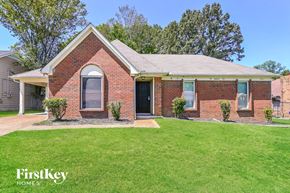 Memphis house for rent - a brick house with a lawn in front of it