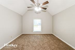 Memphis house for rent - an empty room with a ceiling fan and a window