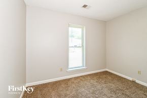 Memphis house for rent - a bedroom with white walls and carpet and a window
