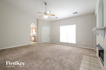 Bessemer house for rent - a spacious living room with carpet and a ceiling fan