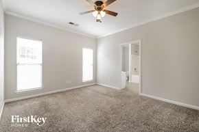 Bessemer house for rent - a master bedroom with carpet and a ceiling fan