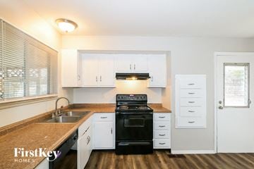 Black Jack house for rent - A kitchen with a sink, stove, and cabinets.