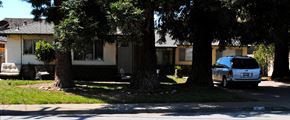 Campbell triplex for rent - Side view of the beige house with brick wall siding with a large green front lawn and a tree in the right hand side of the property Prodesse Property Group 1070 & 1072 Arroyo Seco Drive Campbell, CA 