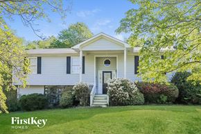 Marietta house for rent - a white house with black shutters and a lawn