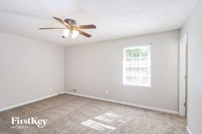 Marietta house for rent - a bedroom with carpet and a ceiling fan