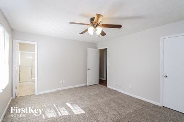 Marietta house for rent - a living room with a ceiling fan and a carpet