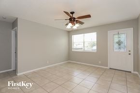 Oakland Park house for rent - a clean and empty living room with a ceiling fan