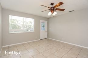 Oakland Park house for rent - a living room with a ceiling fan and a window