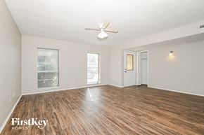 Garland house for rent - a living room with a hard wood floor and a ceiling fan