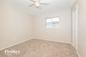 Garland house for rent - a bedroom with carpet and a ceiling fan