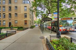 Chicago apartment for rent - a city bus is parked at a bus stop