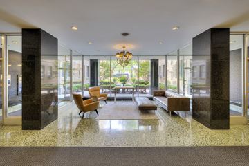 Chicago apartment for rent - a living room with glass walls and a table and chairs