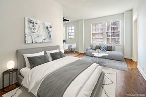Chicago apartment for rent - a bedroom with a bed and a couch and a window