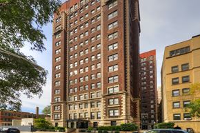 Chicago apartment for rent - a tall building with many windows and a street in front of it