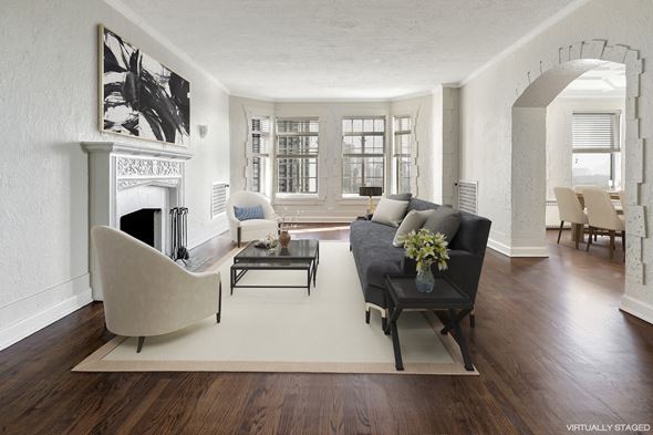 Chicago apartment for rent - a living room with a couch and a chair and a fireplace