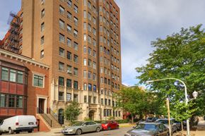 Chicago apartment for rent - a tall brick building on the corner of a city street