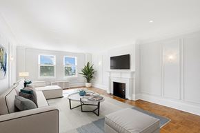 Chicago apartment for rent - a living room with white furniture and a fireplace