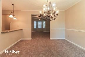 Acworth house for rent - a dining room with carpet and a chandelier