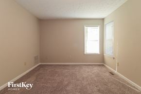 Acworth house for rent - a bedroom with a carpeted floor and a window