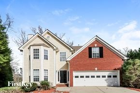 Sugar Hill house for rent - A two-story house with a red brick chimney and a white garage door.