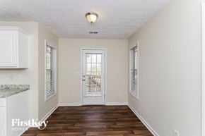 Sugar Hill house for rent - A room with a wooden floor and a white door.