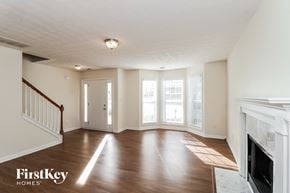 Sugar Hill house for rent - A spacious living room with wood flooring and a fireplace.