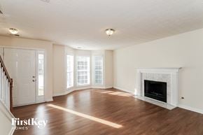Sugar Hill house for rent - A living room with a fireplace and wooden floors.