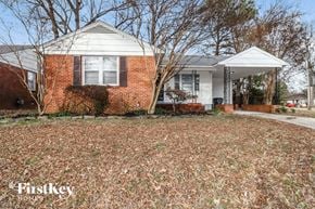 Memphis house for rent - a small brick house with a yard in front of it