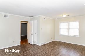Memphis house for rent - the living room of a home with a wood floor and white walls and a door