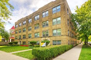 Chicago apartment for rent - a large brick building with a sidewalk in front of it