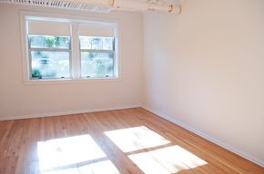 Chicago apartment for rent - an empty room with wooden floors and a window