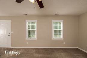 Winston-Salem house for rent - a empty room with two windows and a ceiling fan