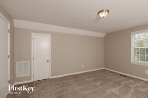 Winston-Salem house for rent - the living room of a home with a carpeted floor and a white door