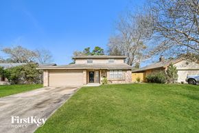 Spring house for rent - a home with a garage and a lawn