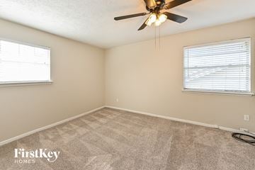 Spring house for rent - the living room of a home with carpet and a ceiling fan