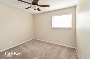 Spring house for rent - a bedroom with a ceiling fan and a window