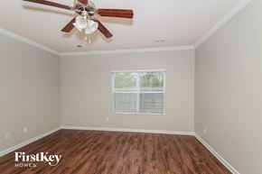 Moody house for rent - a living room with hardwood floors and a ceiling fan